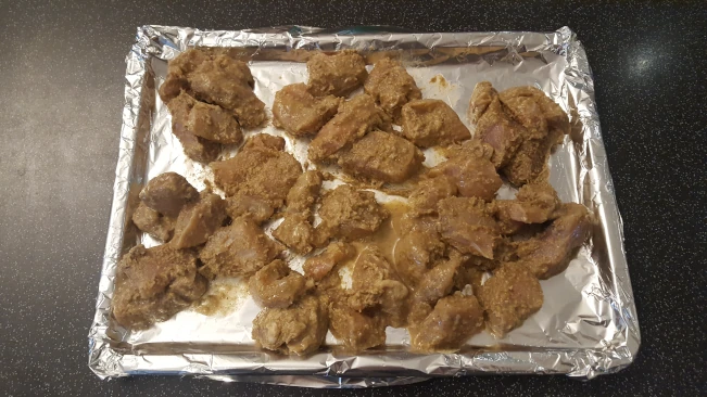 marinated chicken chunks on tray