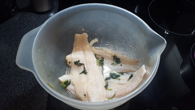 fish fillets marinating in a bowl