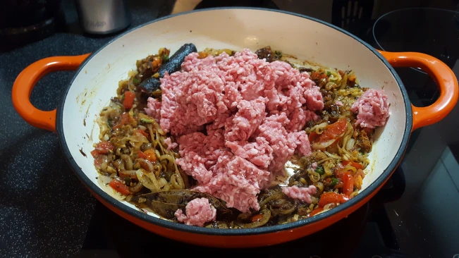 meat added to onions and spices for lamb pulao rice meat added to onions and spices